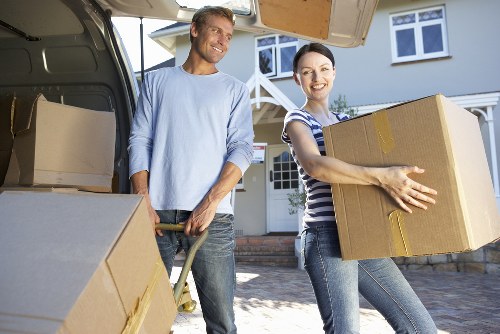 Local movers loading household items into a removal van